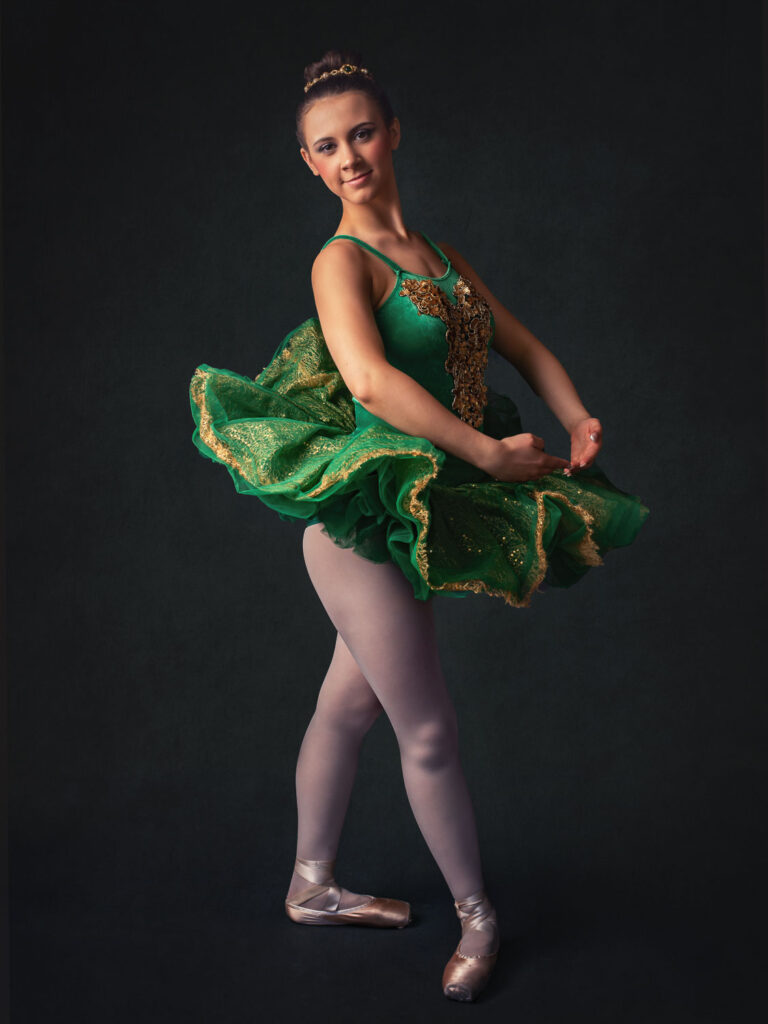 In home portrait session of a ballerina and in a green outfit