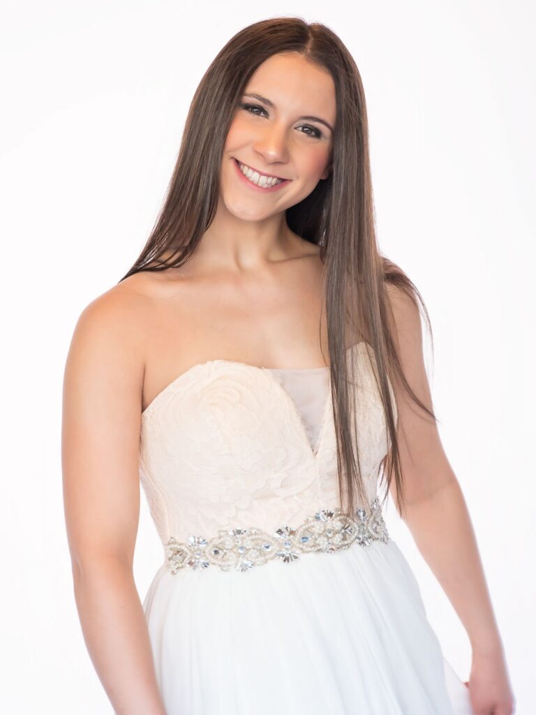 girl smiling wearing a homecoming dress