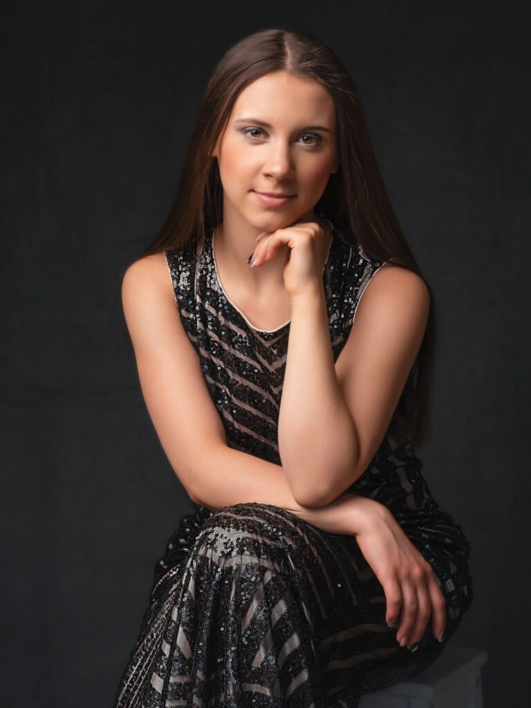 senior girl wearing a black elegant gown in her fashion photo shoot.