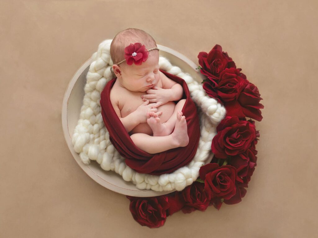 newborn-photo-in-a bowl-with-red-flowers
